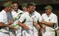 The players congratulate Gareth Pedder on breaking the bowling record
