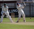Wicket keeper John Huck watches Paul Wilks drive the ball back down the ground