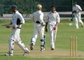 A smiling Kamran Anwar watches Munaf Bavla return to the pavillion after being bowled