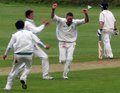 David Makinson celebrates taking the last wicket Chris Harty LBW