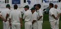 The Morecambe players gather at the fall of a wicket
