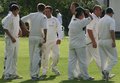 The Morecambe players gather at the fall of  David Makinson's wicket